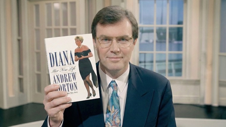 Author Andrew Morton during a television interview with Dini Petty while holding a Princess Diana book